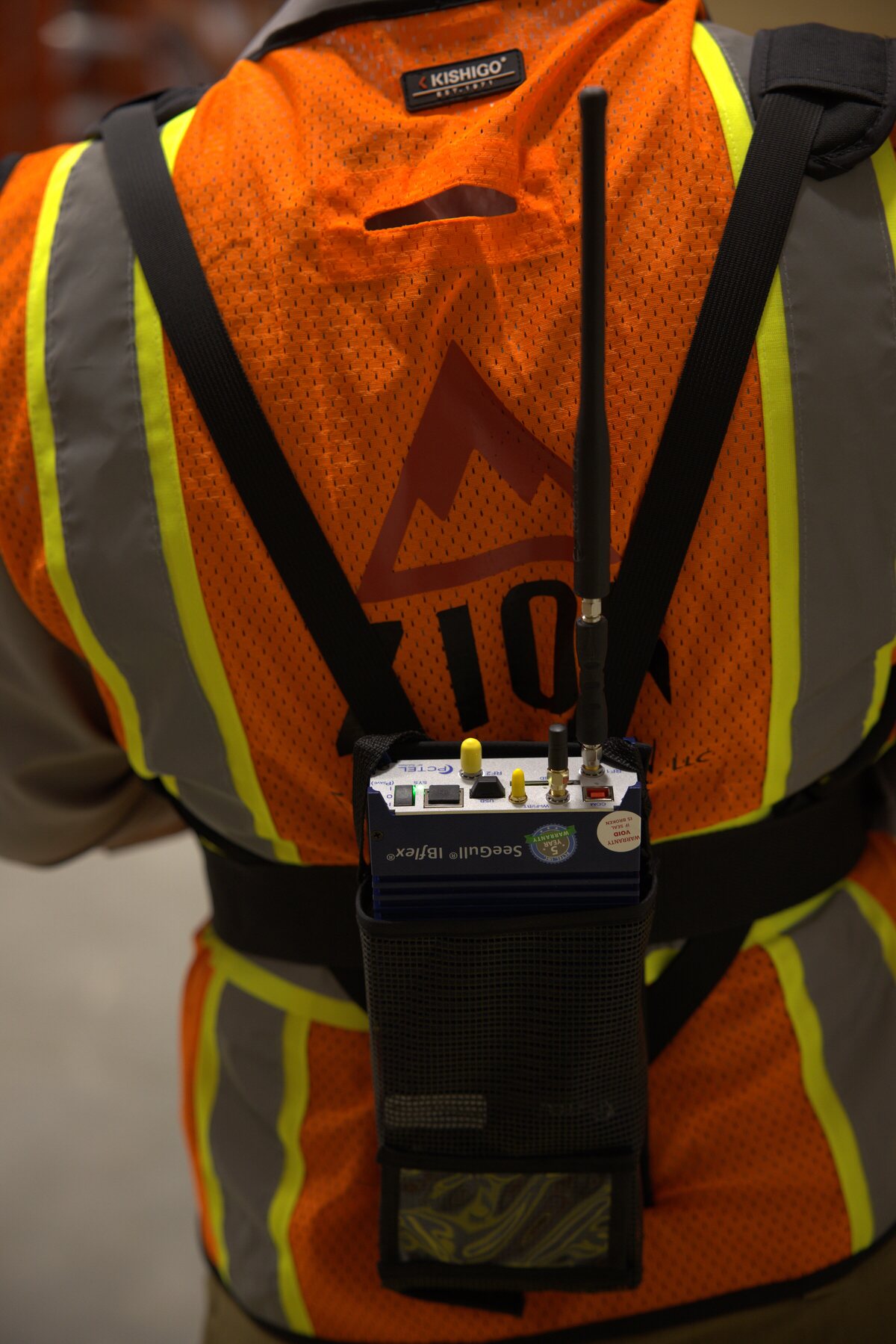 Joel Sadowsky wearing a Zion vest with a PCTEL SeeGull IBflex signal analyzer harness — the field-grade RF testing that Building Signal Check pre-scopes for owners in 60 seconds